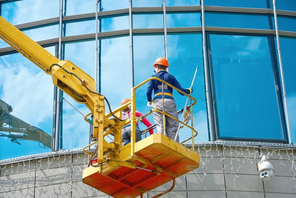 Maintenance crew in a yellow lift basket representing cherry picker hire services
